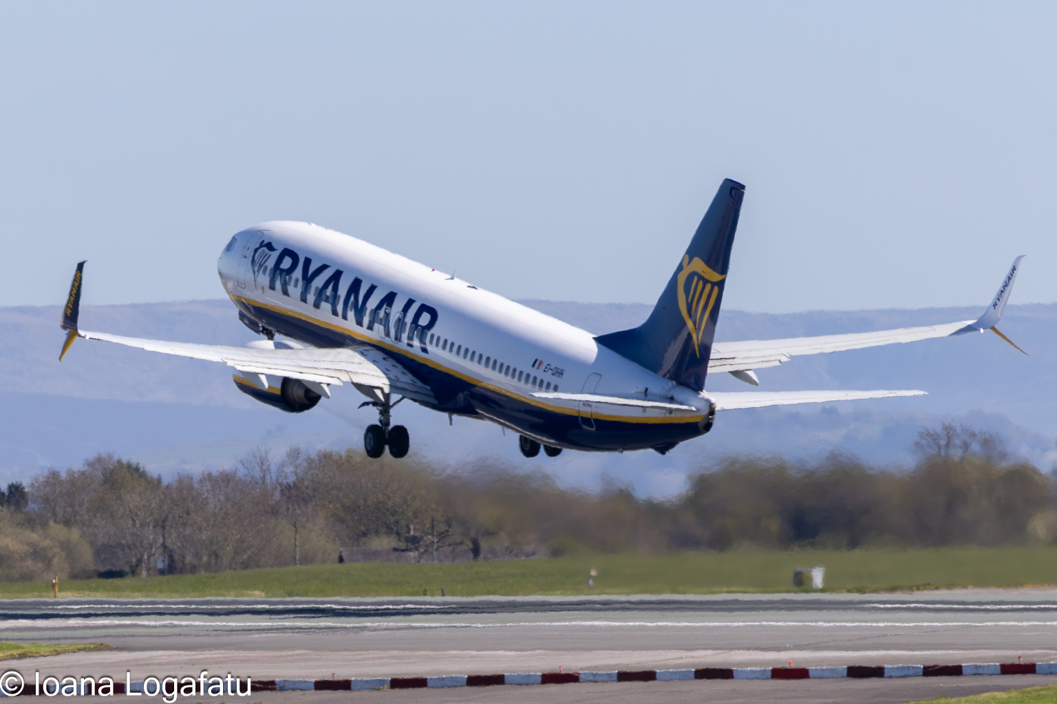 Airplane climbs into clear blue skies